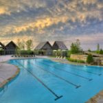 community pool with swimming lanes and slide