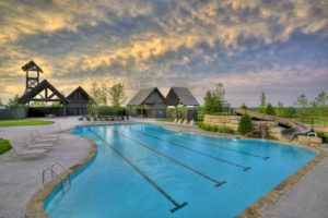 community pool with swimming lanes and slide